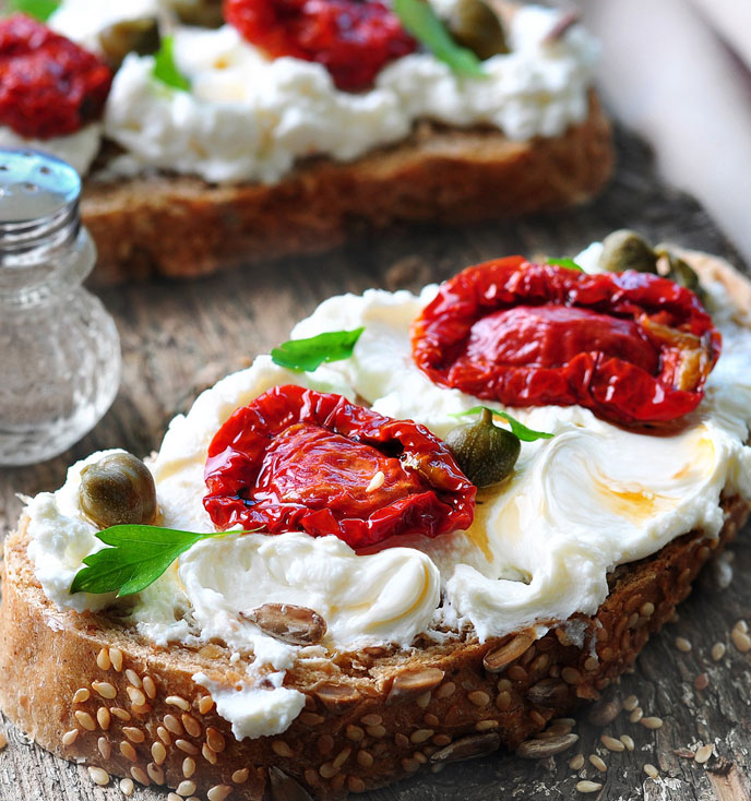 Mediterranean Toasts with Fresco Spalmabile and Sun-dried Tomatoes